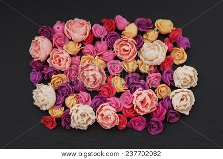 Mix Of Pink And Peach Fake Plastic Mini Rosess Flowers Black Background Copy Space. Craft, Art,
