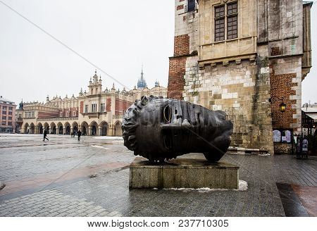 Krakow, Poland - January, 2014: Head Sculpture Eros Bendato On Market Square By Artist Igor Mitoraj 