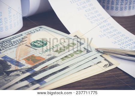Closeup Us Banknotes, Money Dollor, Silver Pen And Financial Bills On Wooden Table, Vintage Style. C