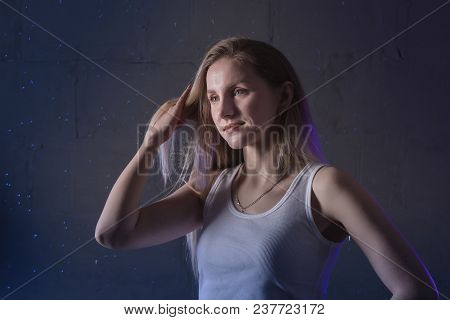 Portrain Of The Girl In The White Shirt With Water Drop In A Dark Room Illuminated By Light During A