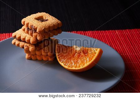 Group Of Chocolate Halloween Cookies On Plate And Red And Black