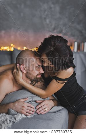 Girl Gently Hugs The Neck, A Bald Beefy Man.