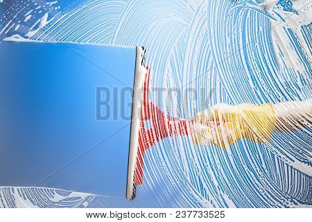 Cleaning Window With Squeegee Blue Sky. Studio Shot