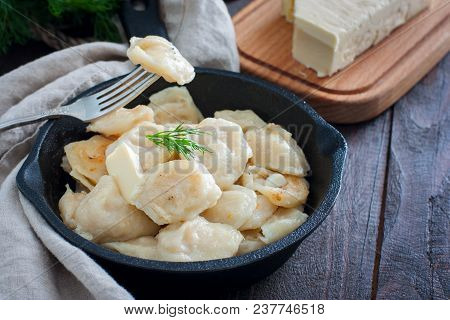 Fried Dumplings With Cabbage In A Portioned Cast-iron Frying Pan, Selective Focus