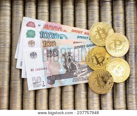 Gold Krypto Coins Bitcoin Btc, Paper Notes Of Russian Rubles. Metal Coins Are Laid Out In A Backgrou