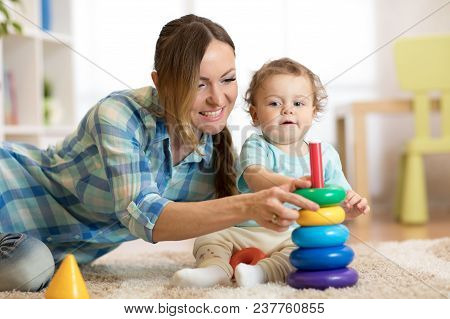 Baby Boy And His Mommy Playing With Toys At Home