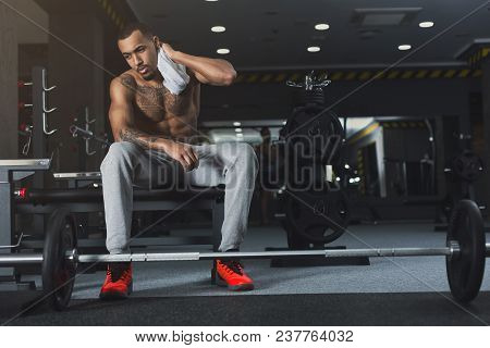Naked Muscular African-american Bodybuilder Having Rest After Heavy Deadlifts In Modern Fitness Cent