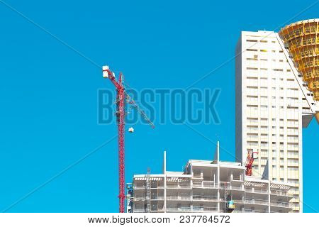 Benidorm, Spain - February 16, 2018: Crane Working On New Construction Site Near In Tempo Skyscraper