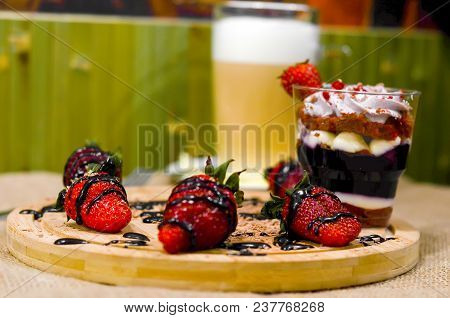 Sweet English Trifle Dessert With Blueberry Cream , Strawberries And Gkass Of Coffee Latte Back On A