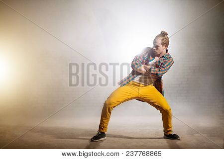 Young Male With Crossed Arms And Legs Apart Is Waiting For His Solo In Dance. Presenting His Dance S