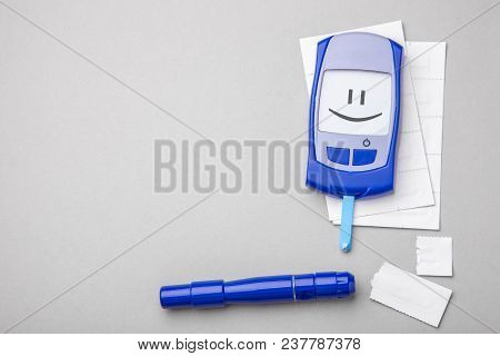 Diabetes Mellitus, Increased Blood Sugar Levels. Smiling Face On Display. Gray Background. Copy Spac