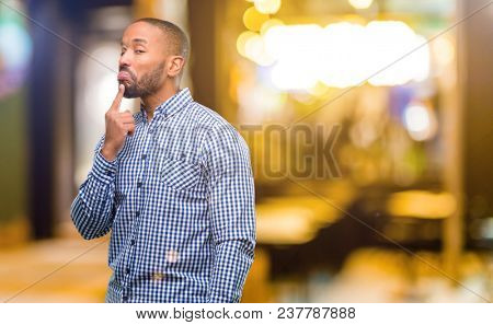 African american man with beard having skeptical and dissatisfied look expressing Distrust, skepticism and doubt at night