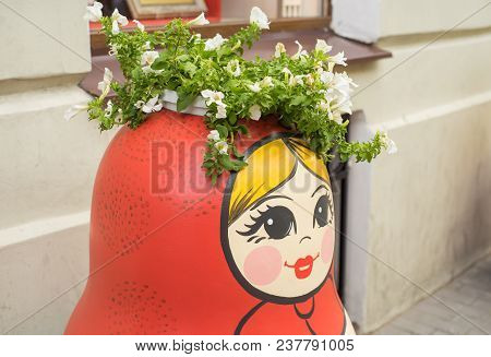Russian Traditional Wooden Doll Matreshka Decorated With Painted Flowers And Patterns Standing On Th