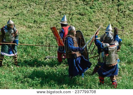 Luh, Russia - August 27, 2016: Reconstruction Of Medieval Battle Of Knights In Armor And Weapons At 