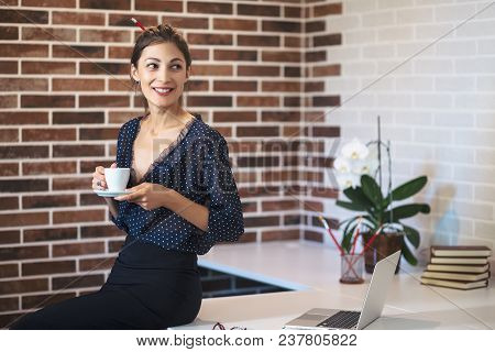Positive Smiling Business Woman, Holding A Cup Of Coffee In Hands Turned Her Head With A Happy Expre