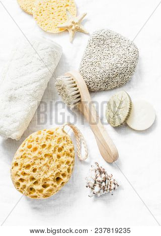 Shower Accessories - Face Brush, Sponge, Pumice Stone, Towel, Soap On A Light Background, Top View. 