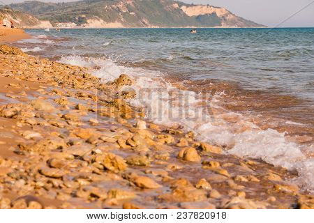 View To The Shore With Stones Sand In Europe.landscape Coastline With Stones On Sunny Day