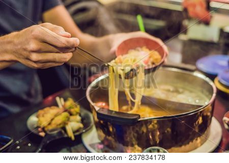 The Man Puts The Soup In A Plate.