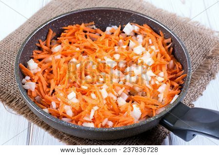 Stewing Carrots With Onions In Frying Pan. Preparation Of Roast To Soup