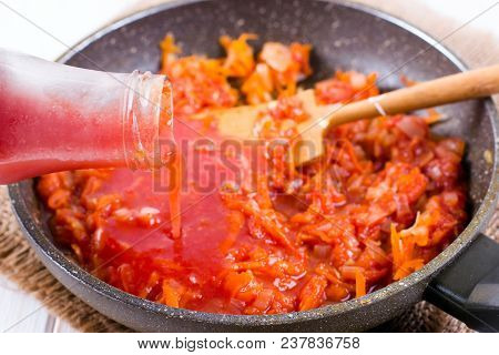 Adding Tomato Paste To Vegetables In A Frying Pan For Borscht