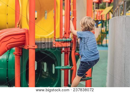 Funny Cute Happy Baby Playing On The Playground. The Emotion Of Happiness, Fun, Joy.