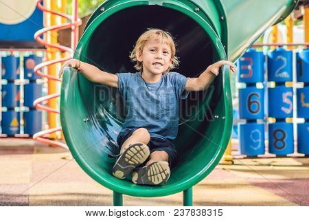 Funny Cute Happy Baby Playing On The Playground. The Emotion Of Happiness, Fun, Joy.