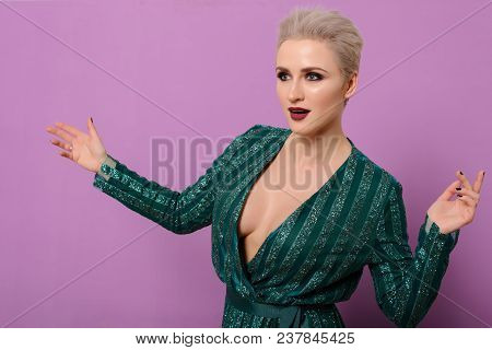 Beautiful Female Swede Of Middle Age With Short-cut Blond Hair And Green Evening Dress Positively Po