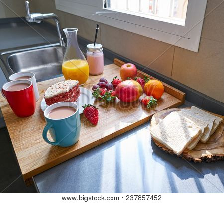 Breakfast in kitchen with coffee bread fruit juice and cake