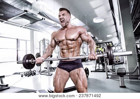 Muscular Bodybuilder Guy Doing Exercises With Dumbbell
