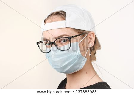 Girl In Medical Mask With Respirator On White Background.