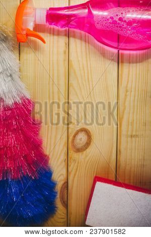 Cleaning House Or Office Concept. Dust Brush, Pink Cleaning Spary And Sponge On A Light Wooden Backg