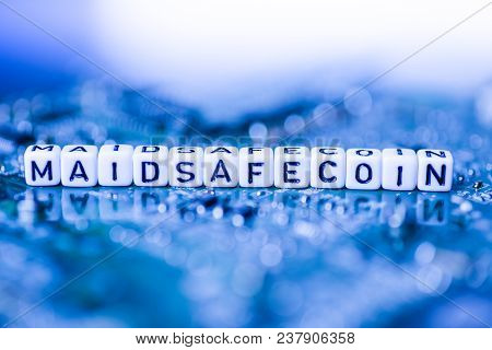 Word Maidsafecoin Formed By Alphabet Blocks On Mother Cryptocurrency Closeup