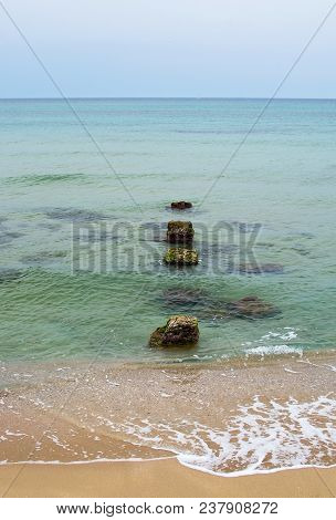 Old Stone Pier In The Green Water In Mallorca, Spain