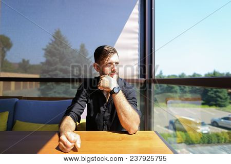 Caucasian Male Ecologist Sitting At Office On Sofa With Trees In Background. Concept Of Business And