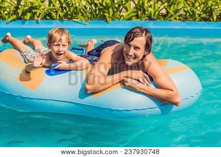 Father And Son Have Fun At The Water Park.