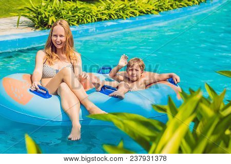 Mom And Son Have Fun At The Water Park.