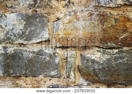 Stone Wall Of Old Masonry Close-up. Background And Texture.