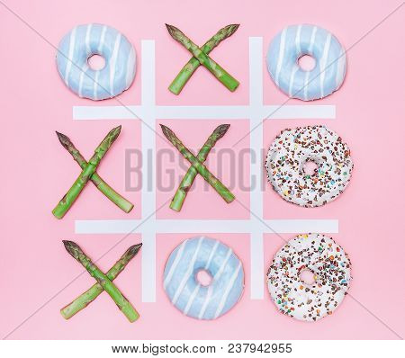 Tik Tak Toe Game With Donuts And Asparagus. Health Nutrition Concept Image