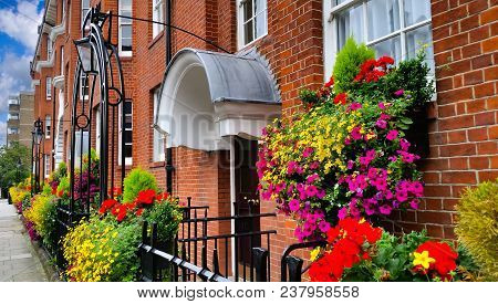 Pretty Apartment Building In London With Blooming Flowers.