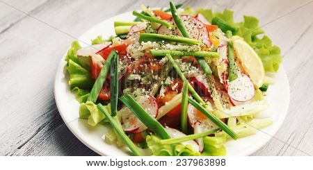 Spring Vegetable Salad On The White Plate. Radish, Tomato, Celery And Cucumber. Topped With Sesame S