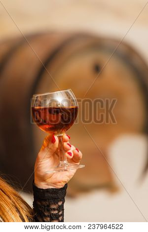 Elegant Lady Tasting Wine In Rural Cottage Interior Celler