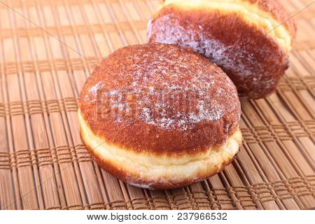 Homemade Doughnuts With Jelly Filled And Powdered Sugar On Bamboo Tablecloth. Selective Focus