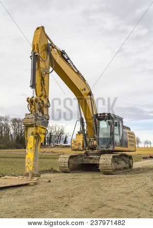 Yellow Excavator At A Loamy Construction Site