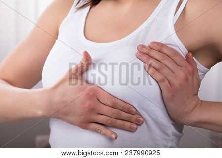 Close-up Of A Woman's Hand On Breast