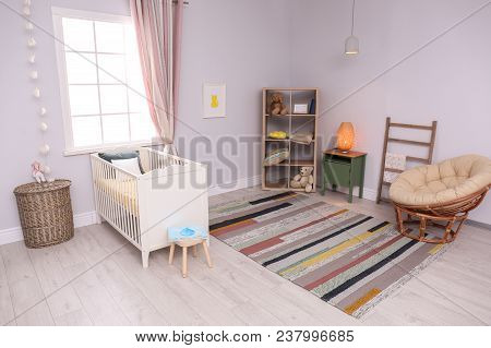 Baby Room Interior With Comfortable Crib And Papasan Chair