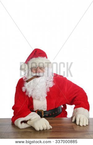 Santa Claus Christmas. Santa enjoys a Fine Cigar while relaxing. Isolated on white. Room for text. Santa enjoys the finer things in life, like Cigars, Hot Coco, Beer, Tequila, Dogs, Cats and more. 