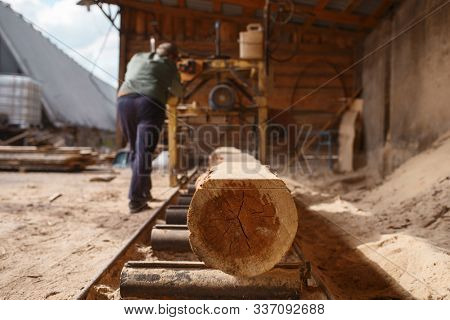 Joiner works on woodworking machine, lumbering