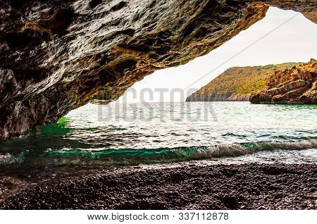 Amazing Seascape View From Unique Sea Cave Overhanging Above Water On Famous Cala Bianca Beach Sceni