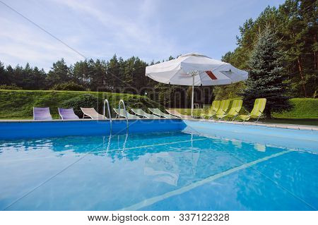 Outdoor Inground Residential Swimming Pool In Backyard.
