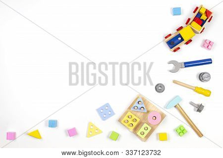 Kids Toys Background. Wooden Train, Educational Geometric Stacking Blocks Toy And Wood Tools Kit On 